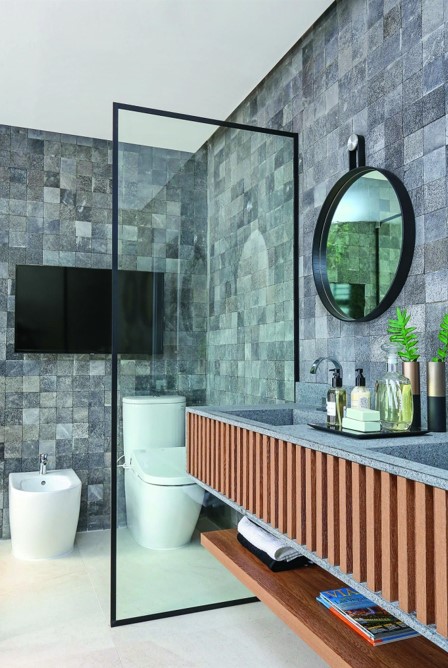 O azulejo pode ser revestido nas paredes em vez de tinta ou papel de parede em uma decoração de banheiro pequeno moderno. Com isso, use também o azulejo em tons escuros na parede de trás para dar um contraste sofisticado.